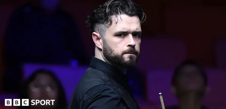 Snooker player focused before taking a shot