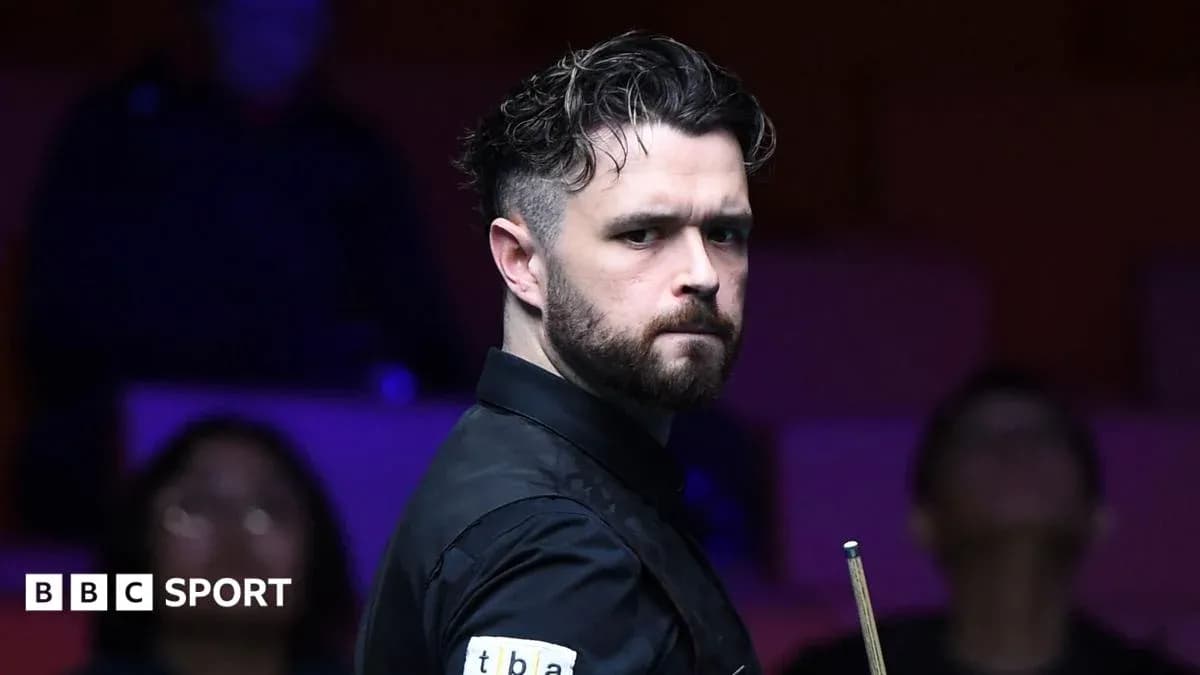 Snooker player focused before taking a shot