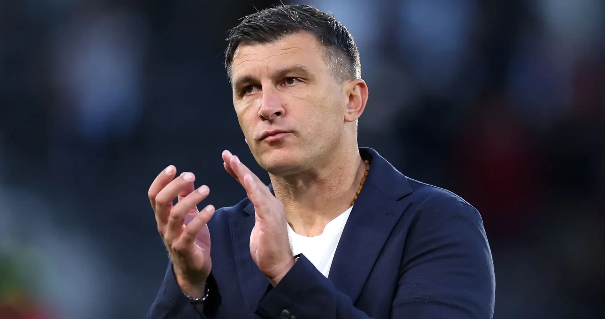Coach clapping hands during match observation
