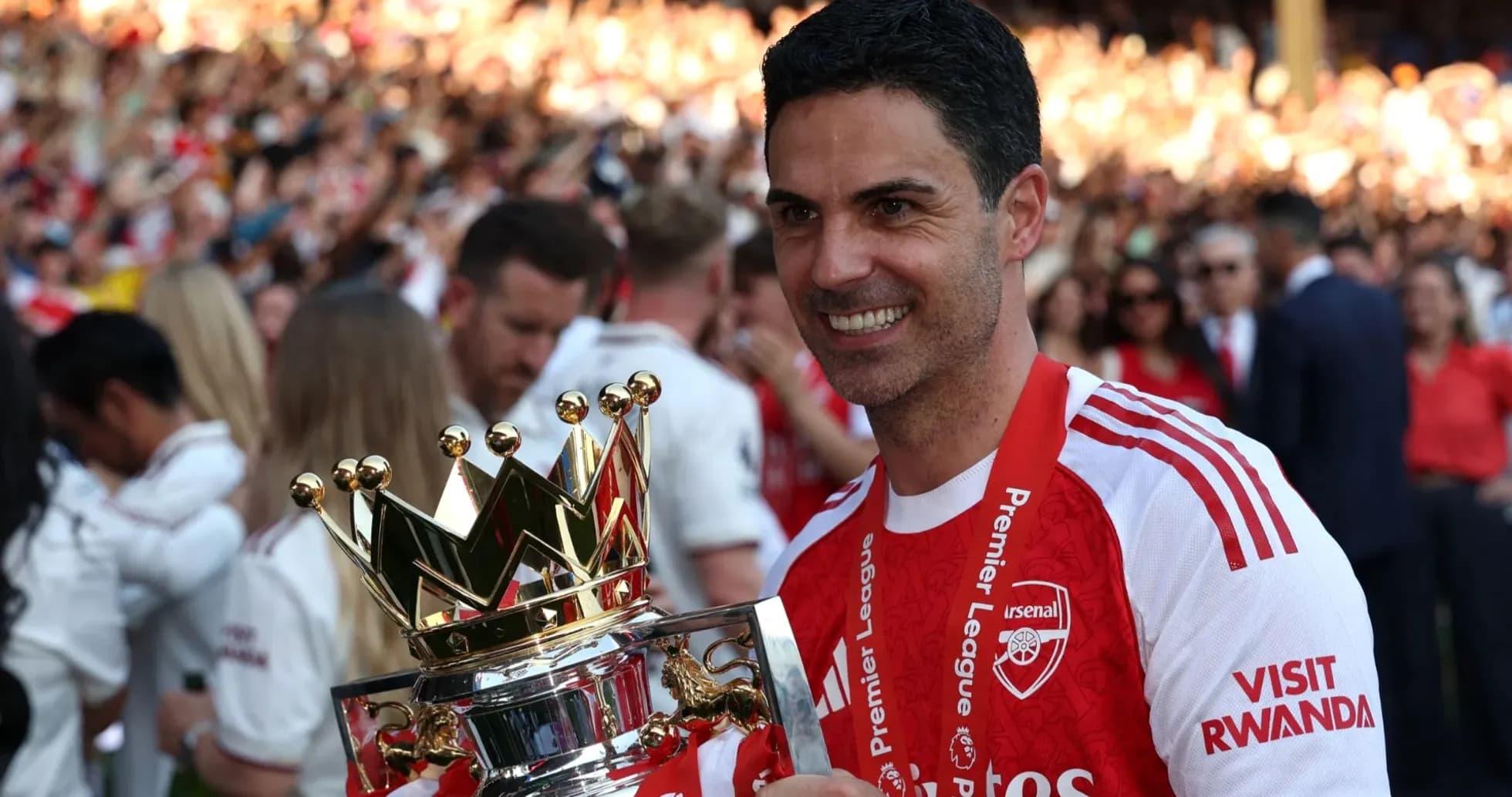 Arsenal manager holding Premier League trophy during celebration Arsenal manager holding Premier League trophy during celebration