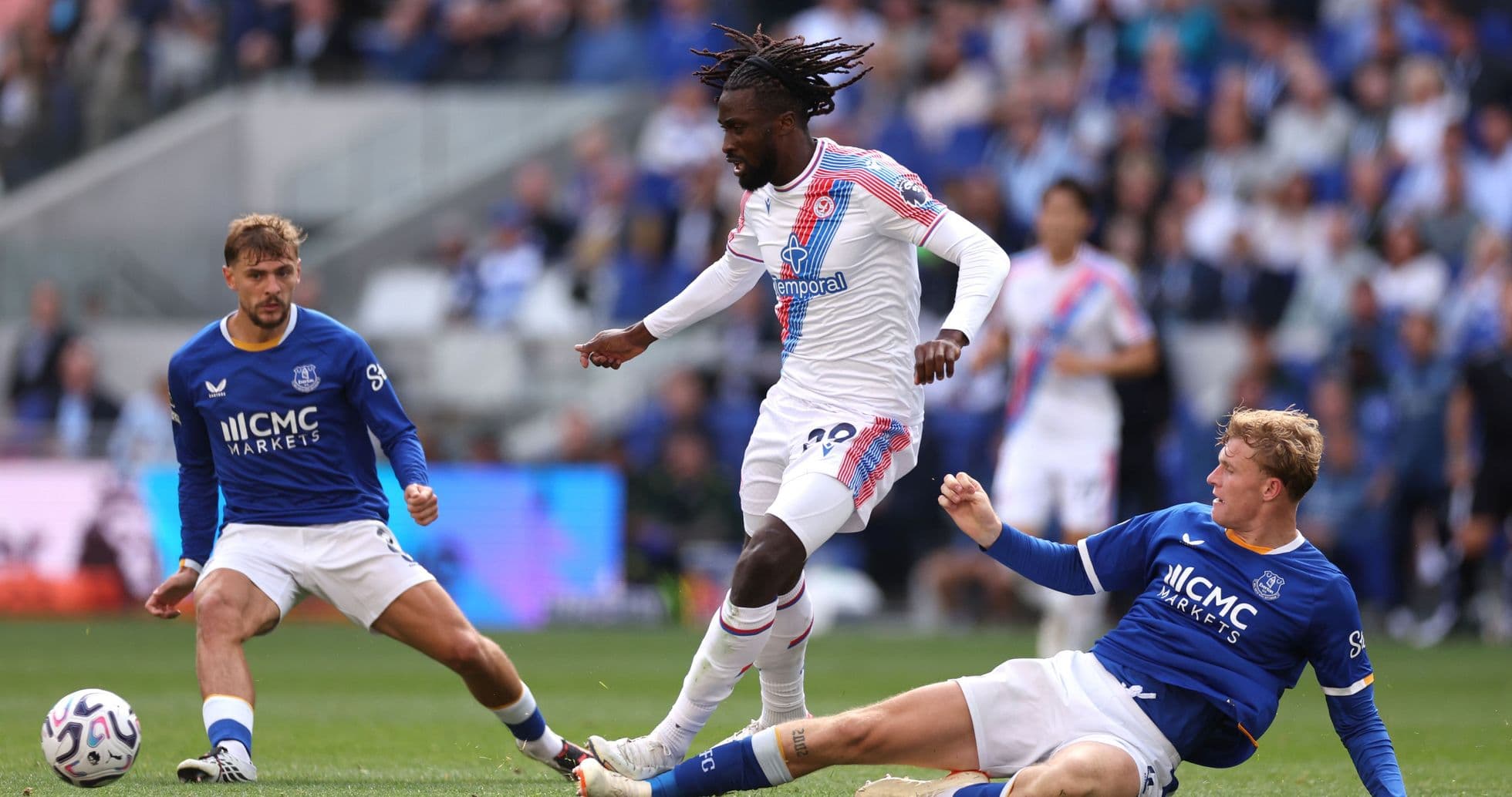 Crystal Palace player dribbling past Everton defenders Crystal Palace player dribbling past Everton defenders