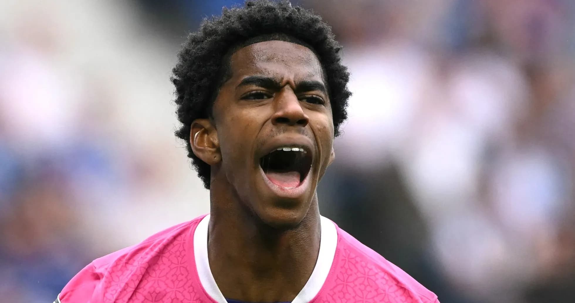 Player in pink jersey shouting on the field Player in pink jersey shouting on the field
