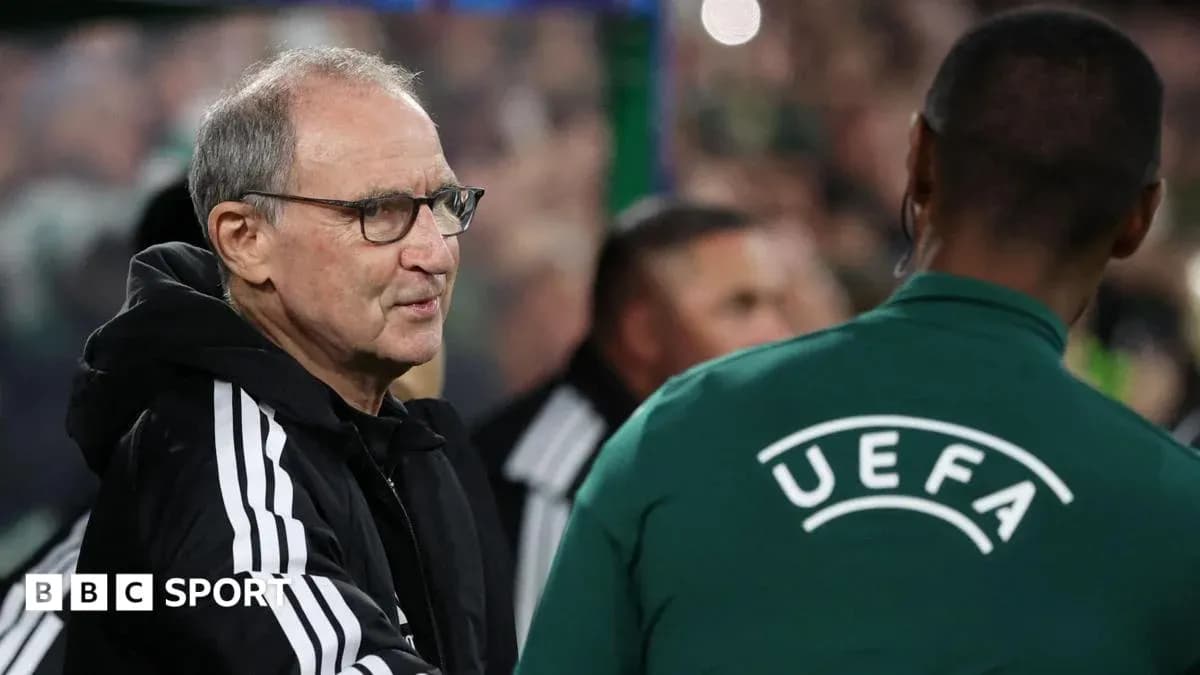Coach interacting with UEFA official during match Coach interacting with UEFA official during match