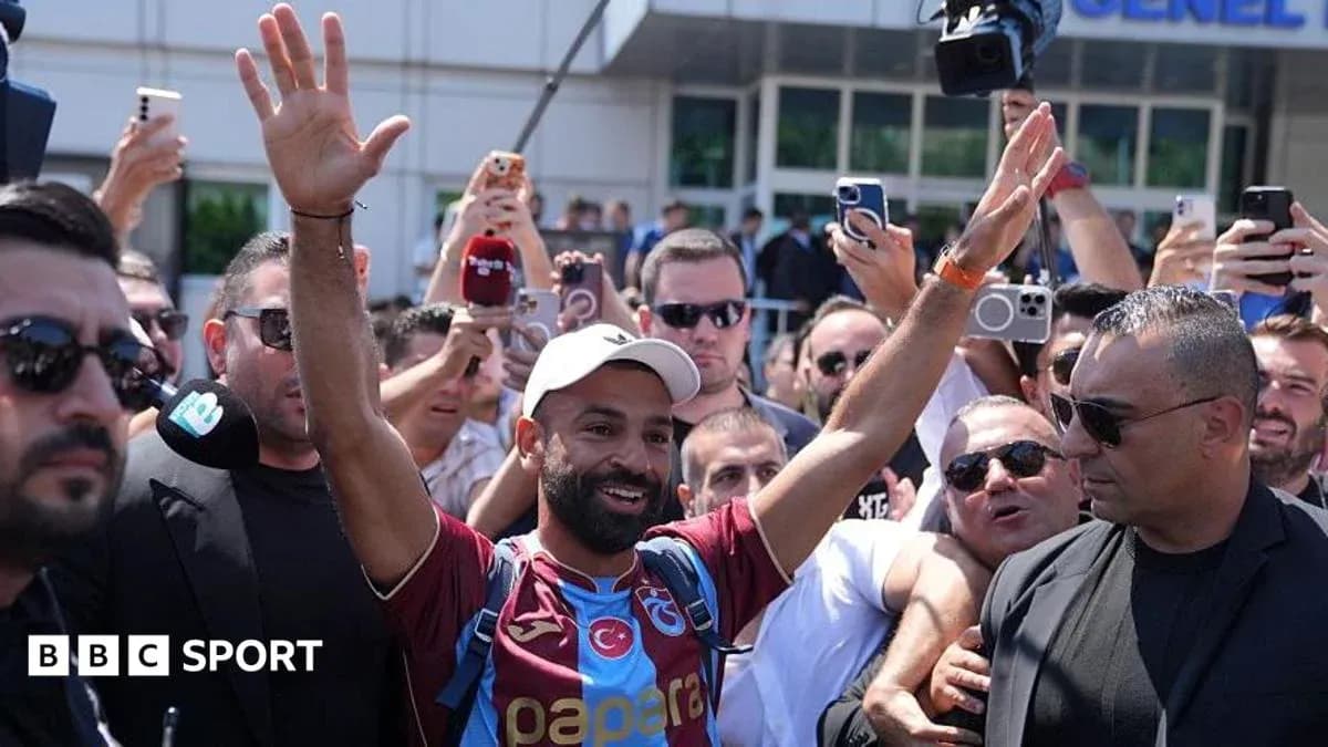 Player waving to fans during arrival event Player waving to fans during arrival event