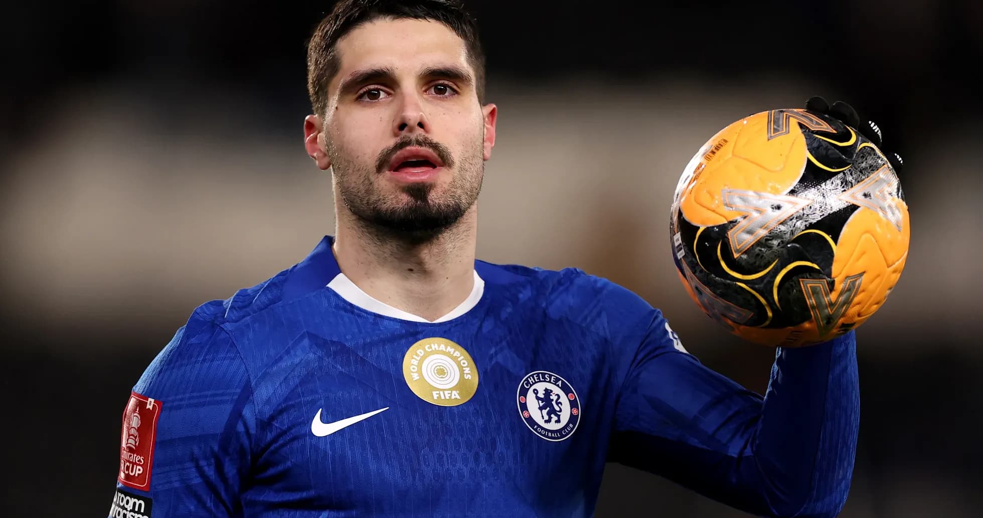 Chelsea player holding the match ball Chelsea player holding the match ball