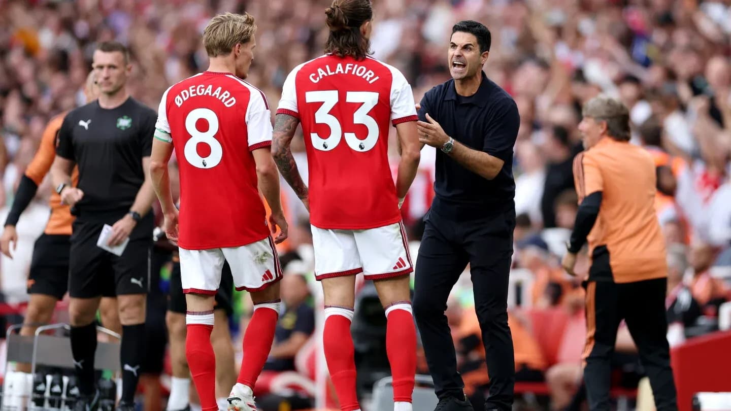 Arsenal players receiving instructions from the coach Arsenal players receiving instructions from the coach