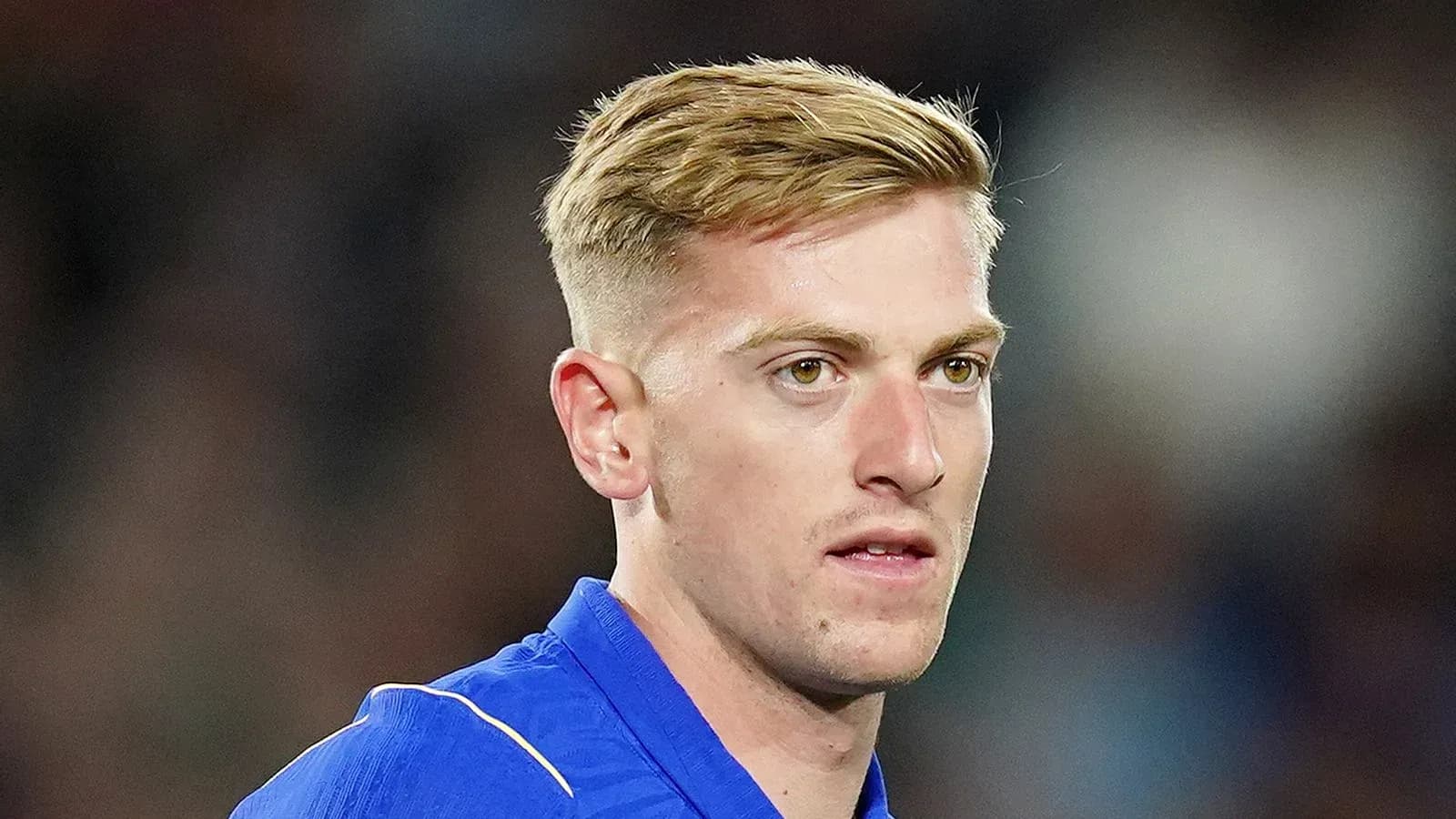 Football player in blue jersey during match Football player in blue jersey during match