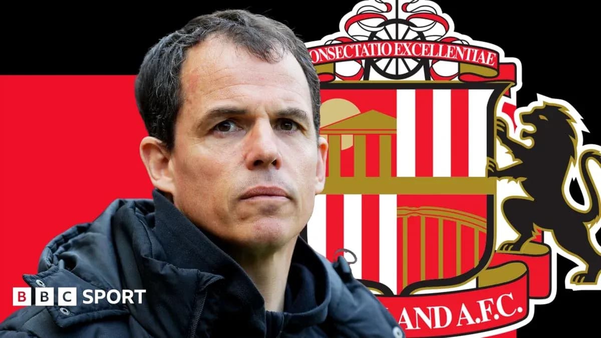Coach in front of Sunderland AFC logo background Coach in front of Sunderland AFC logo background