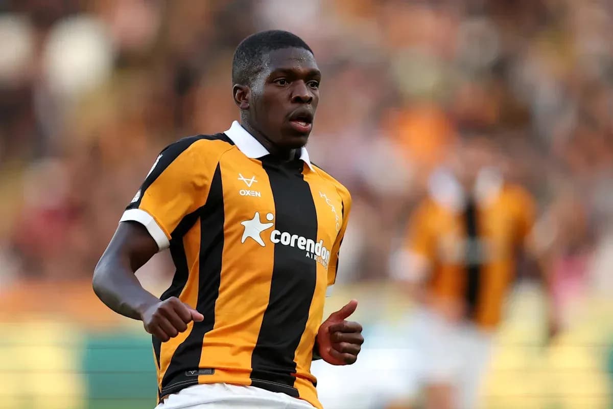 Player running in black and orange jersey during match Player running in black and orange jersey during match