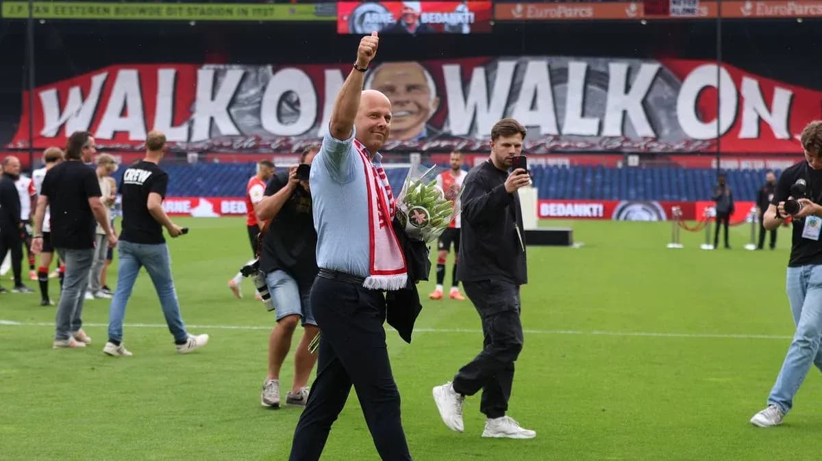 Man waving with bouquet on football pitch Man waving with bouquet on football pitch