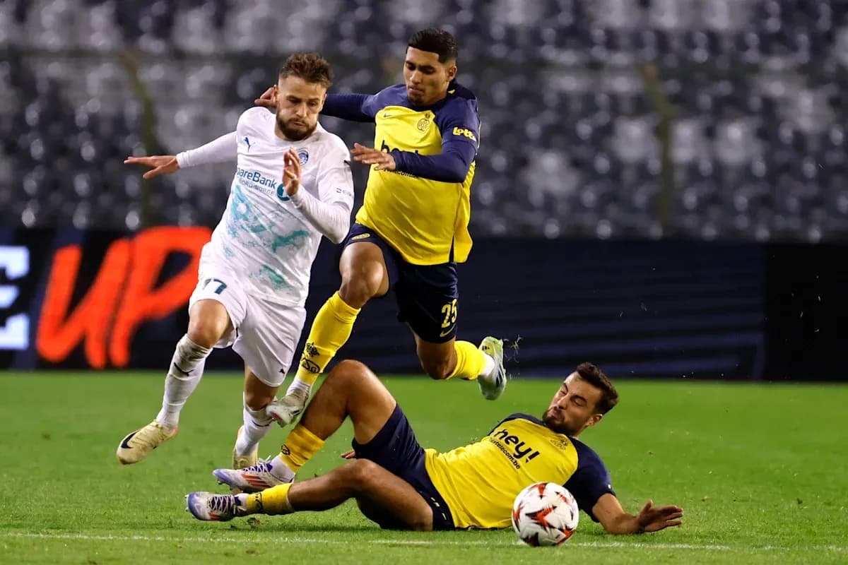 Player evading two defenders during a football match Player evading two defenders during a football match