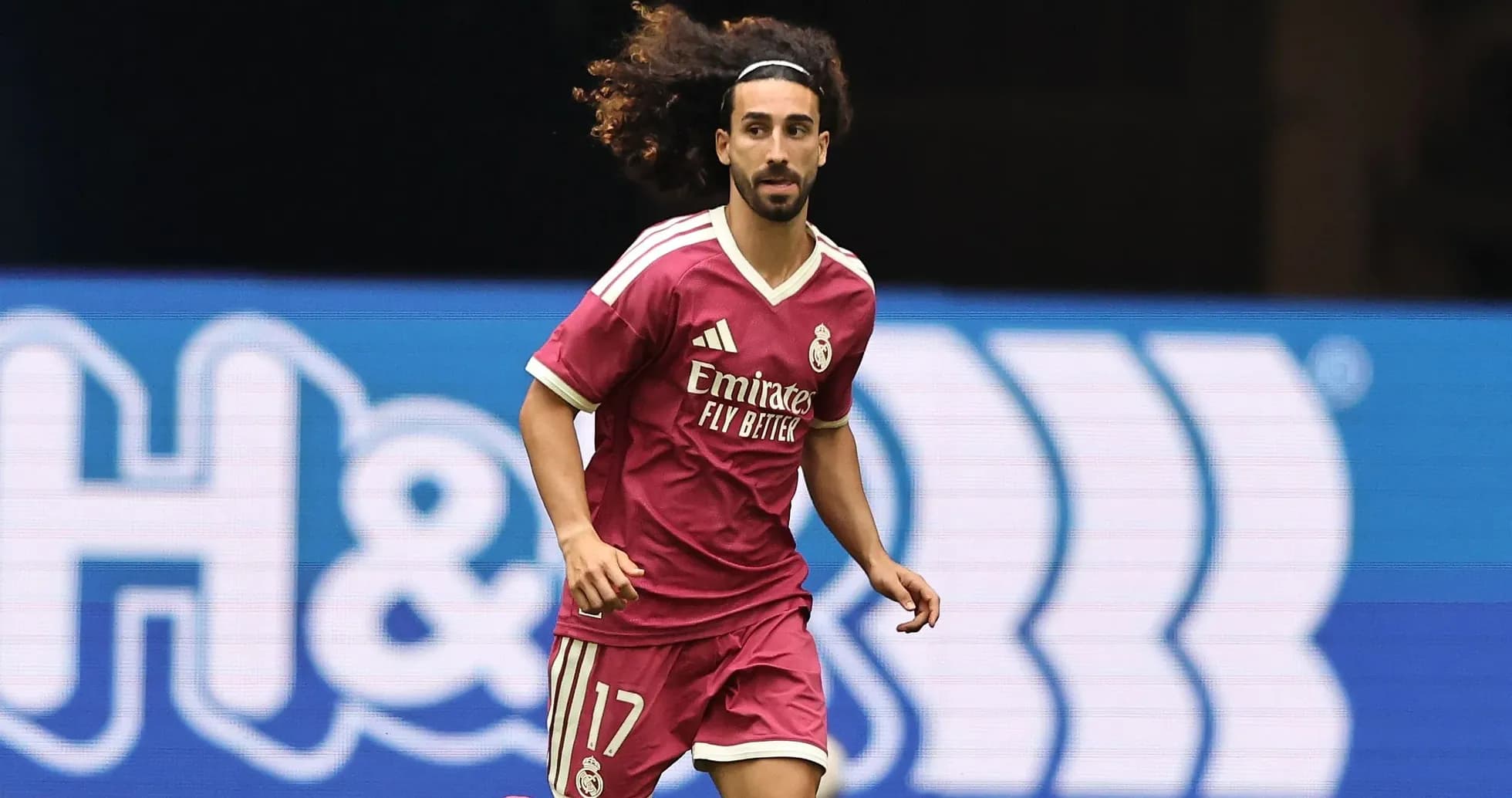 Player in pink kit running during a match Player in pink kit running during a match