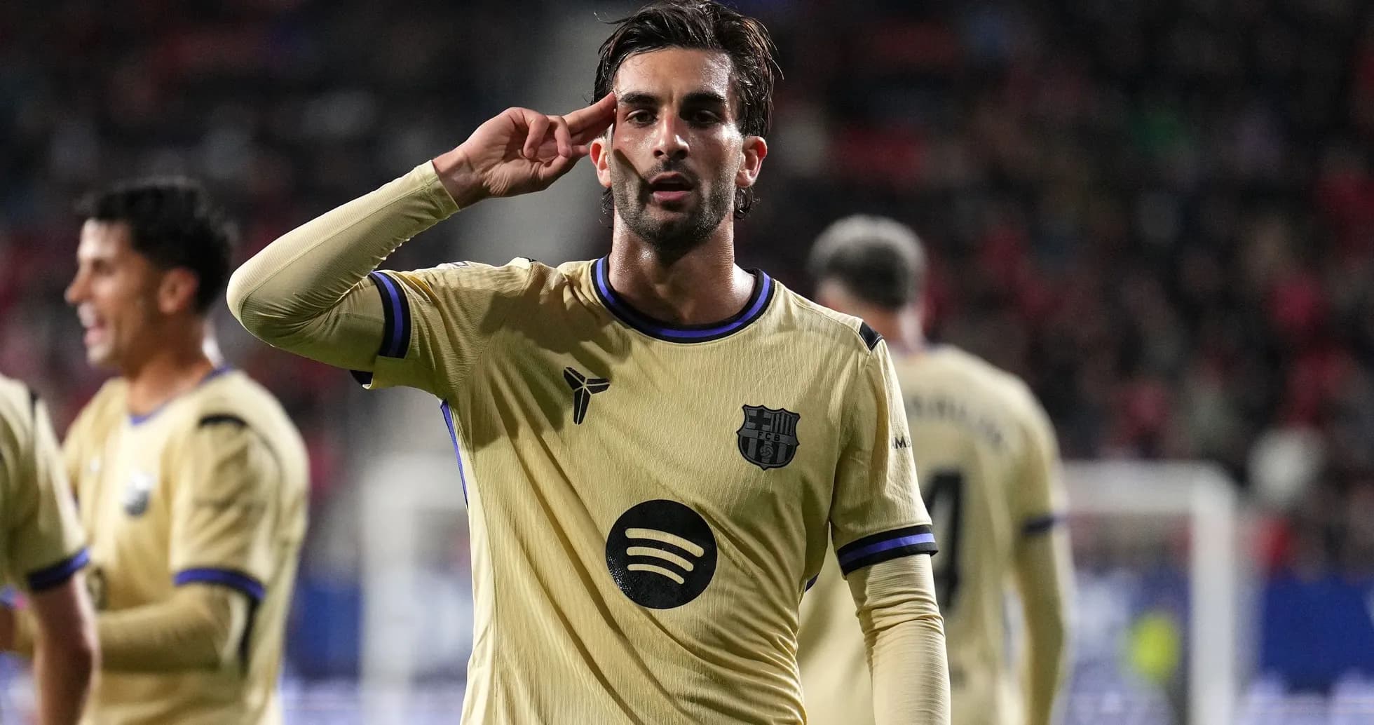 Player celebrating with a salute gesture on pitch Player celebrating with a salute gesture on pitch