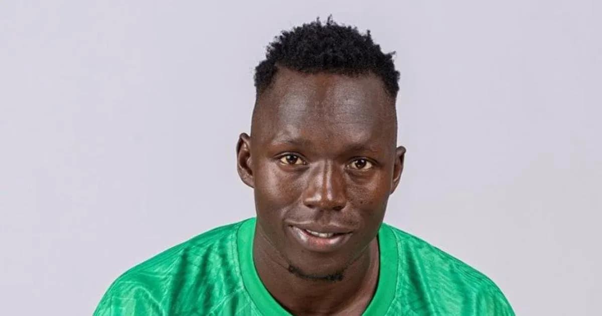 Goalkeeper posing in green kit against plain background Goalkeeper posing in green kit against plain background