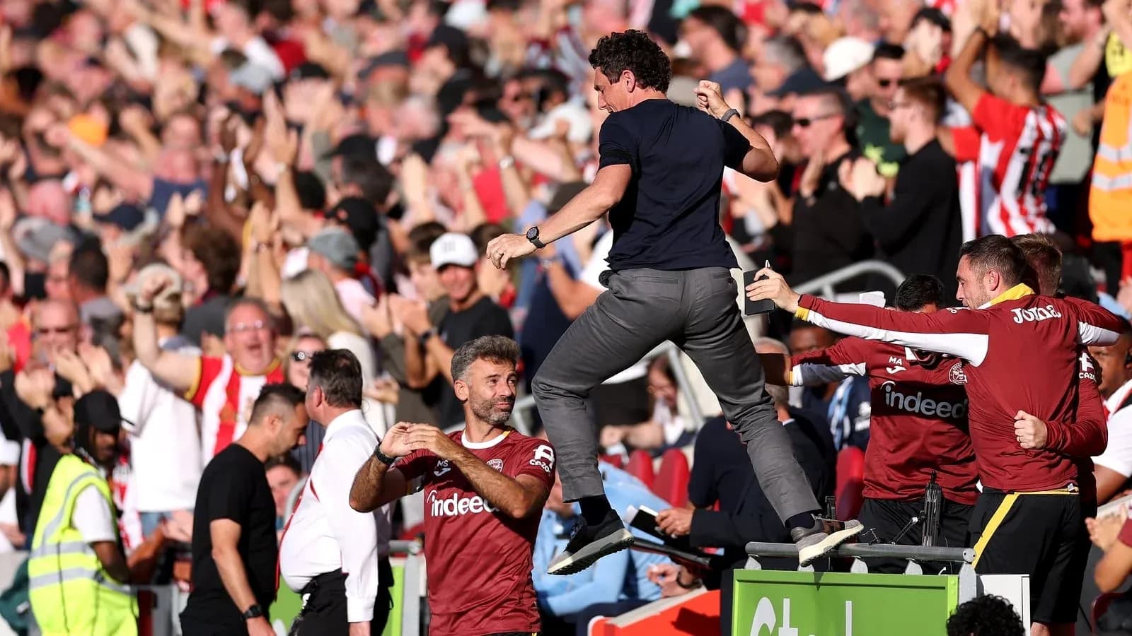 Manager celebrating with fans during match excitement Manager celebrating with fans during match excitement