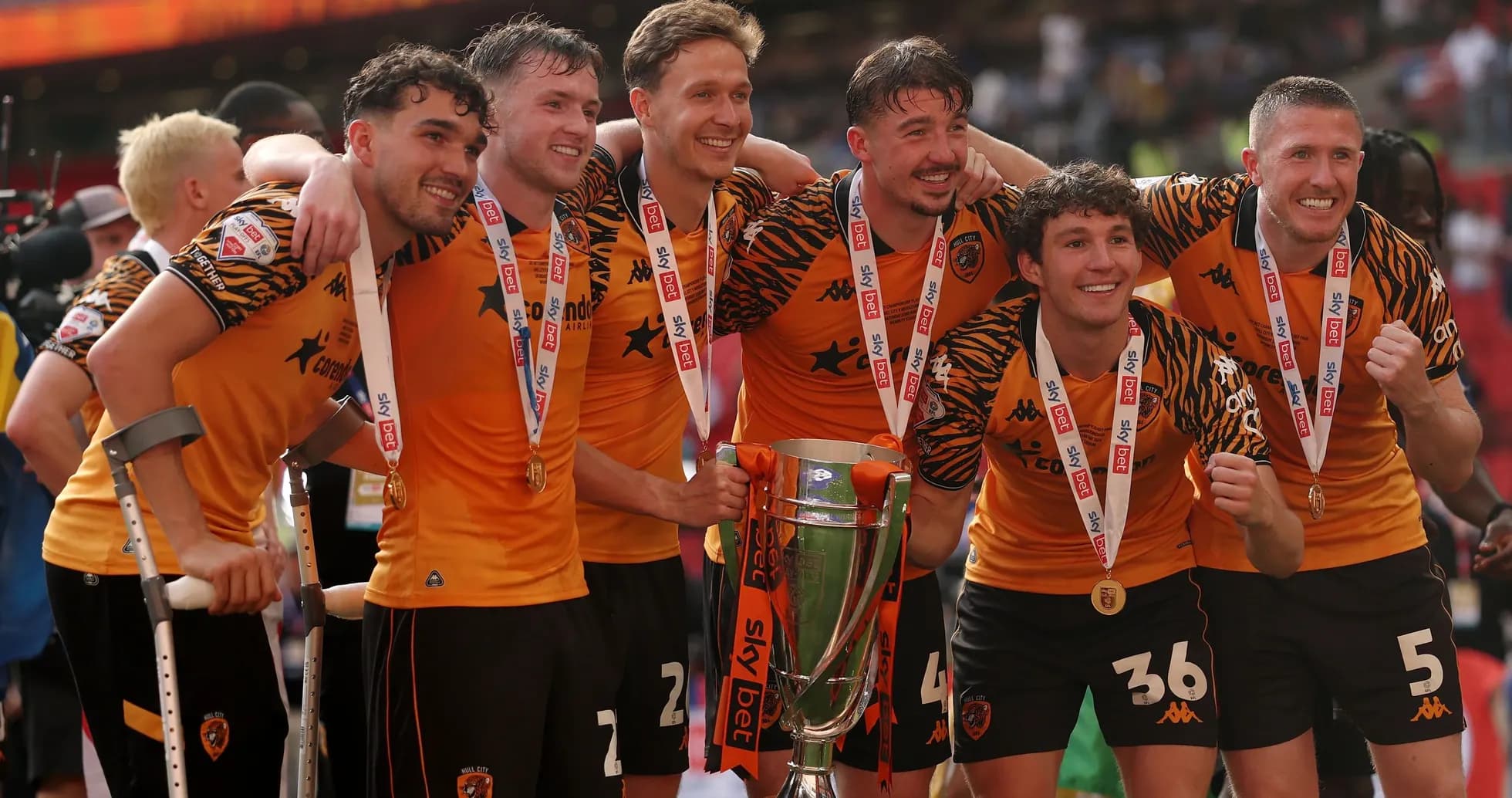 Team celebrating with trophy after championship victory Team celebrating with trophy after championship victory