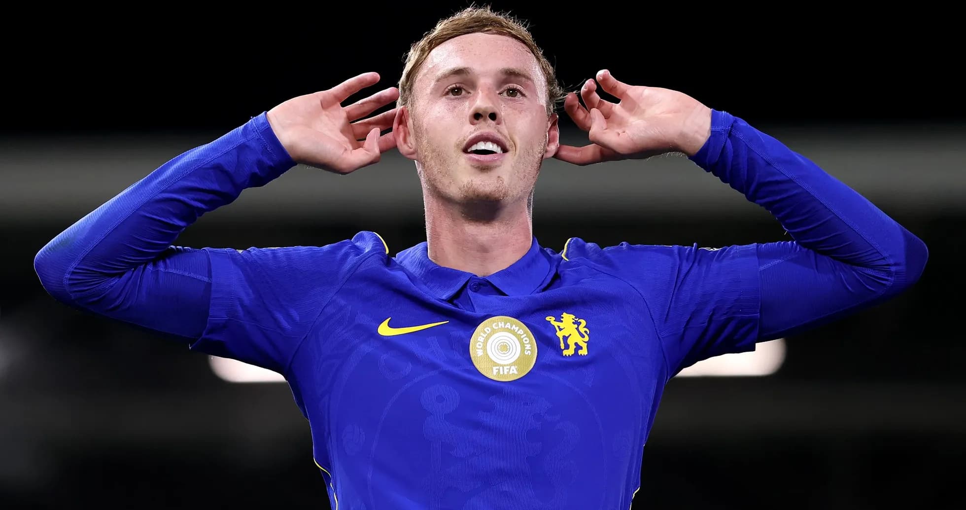 Player celebrating with hands to ears in blue jersey Player celebrating with hands to ears in blue jersey