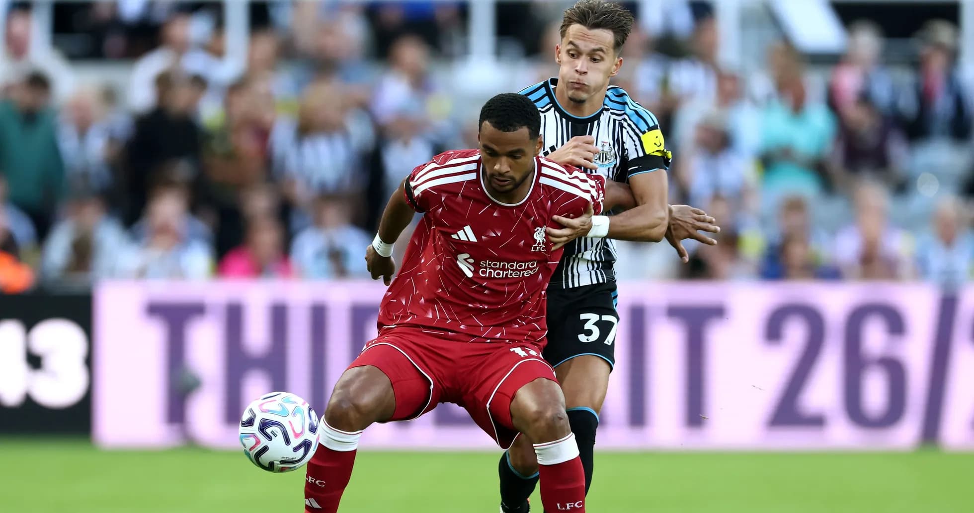 Player from Liverpool evading a Newcastle defender Player from Liverpool evading a Newcastle defender