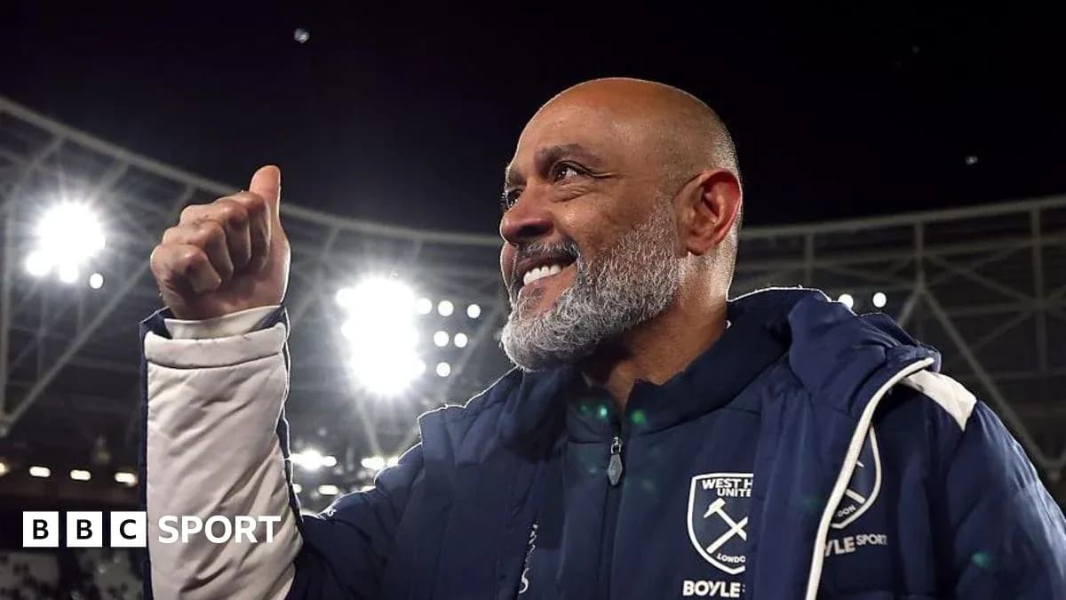 Manager celebrating with thumbs up in stadium Manager celebrating with thumbs up in stadium