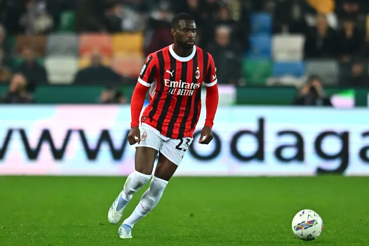 Player in AC Milan kit dribbling the ball Player in AC Milan kit dribbling the ball