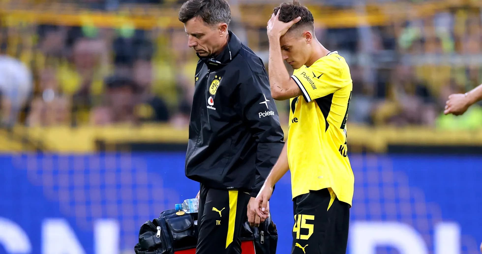 Player receiving medical attention after injury on field Player receiving medical attention after injury on field