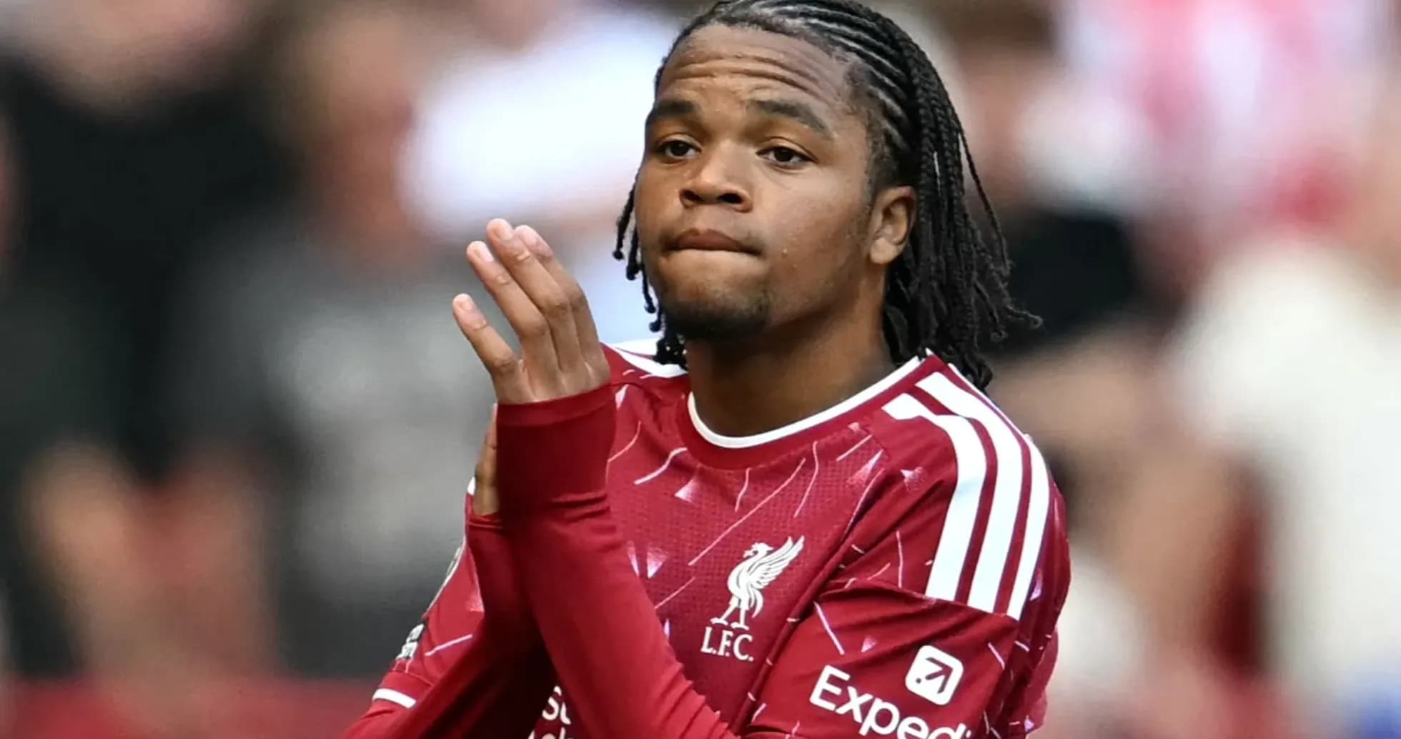 Player clapping in Liverpool FC jersey on field Player clapping in Liverpool FC jersey on field