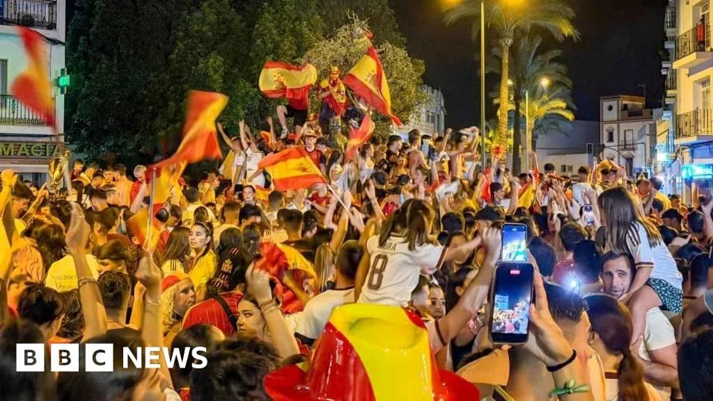 Crowd celebrating with flags in a street at night Crowd celebrating with flags in a street at night