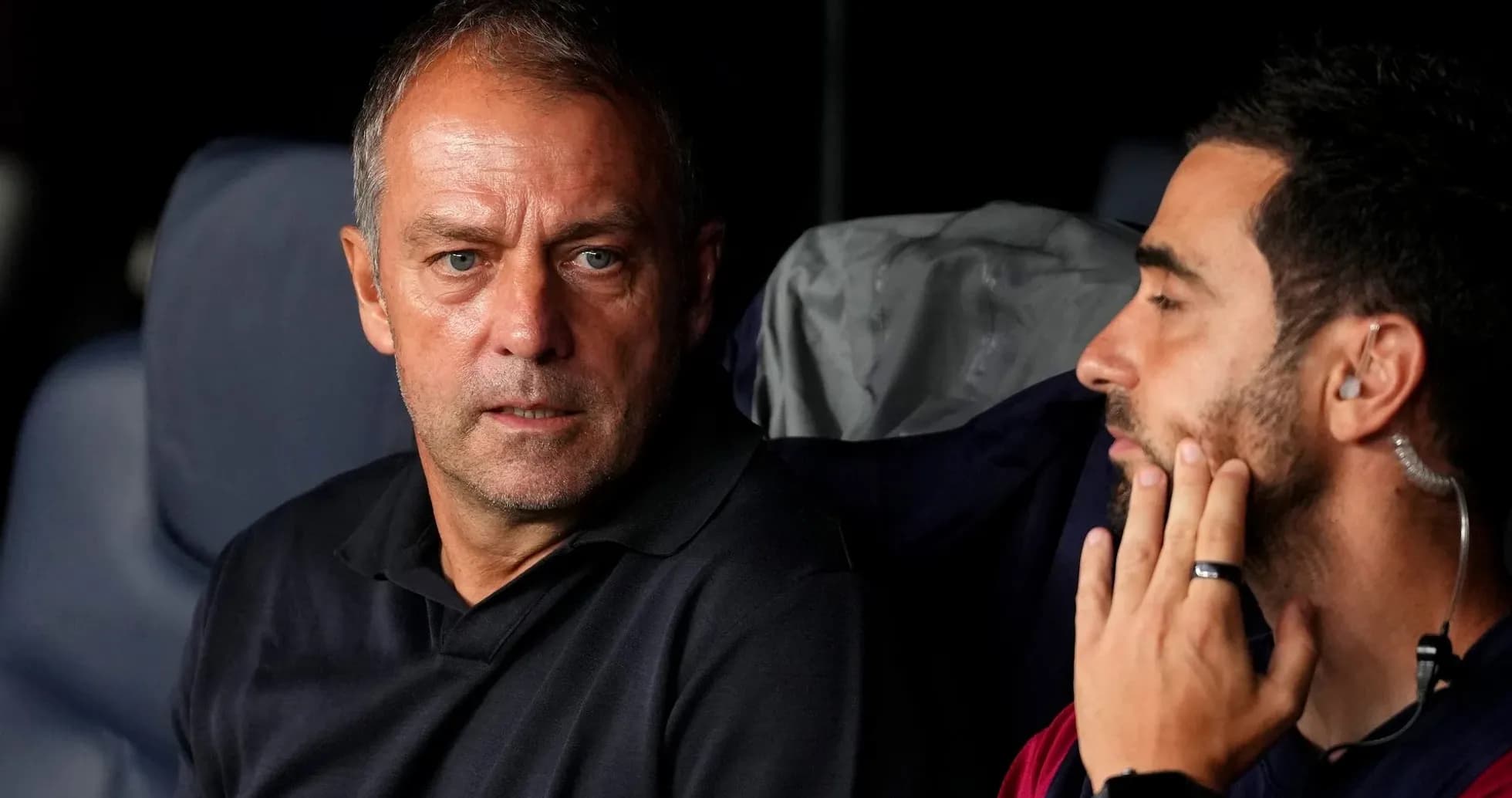 Two coaches discussing strategies on the bench Two coaches discussing strategies on the bench
