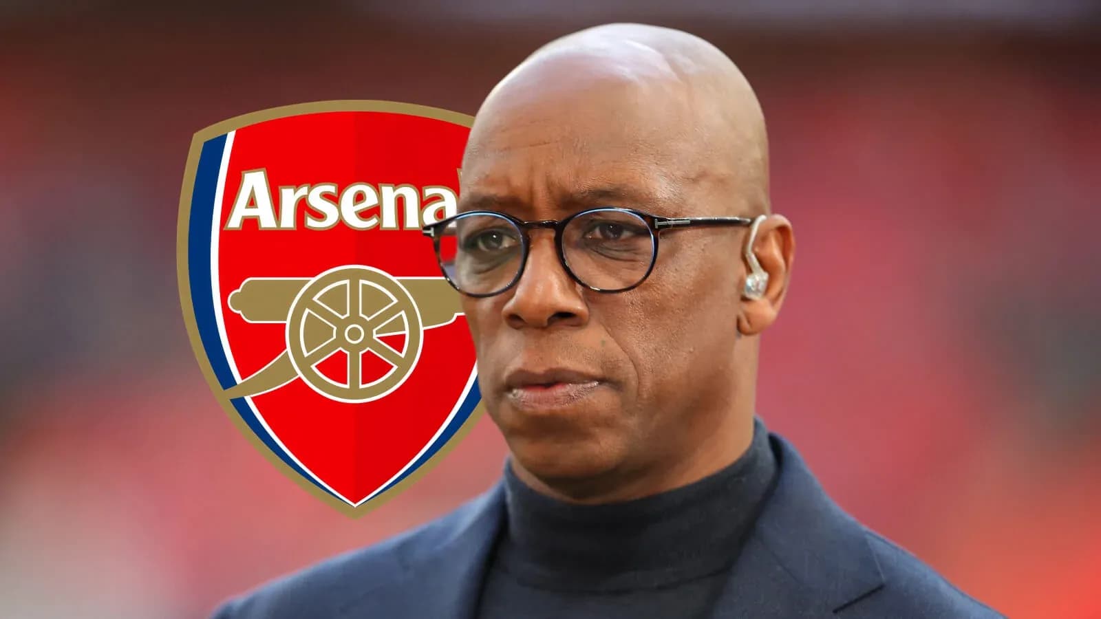 Man in glasses with Arsenal logo in background Man in glasses with Arsenal logo in background
