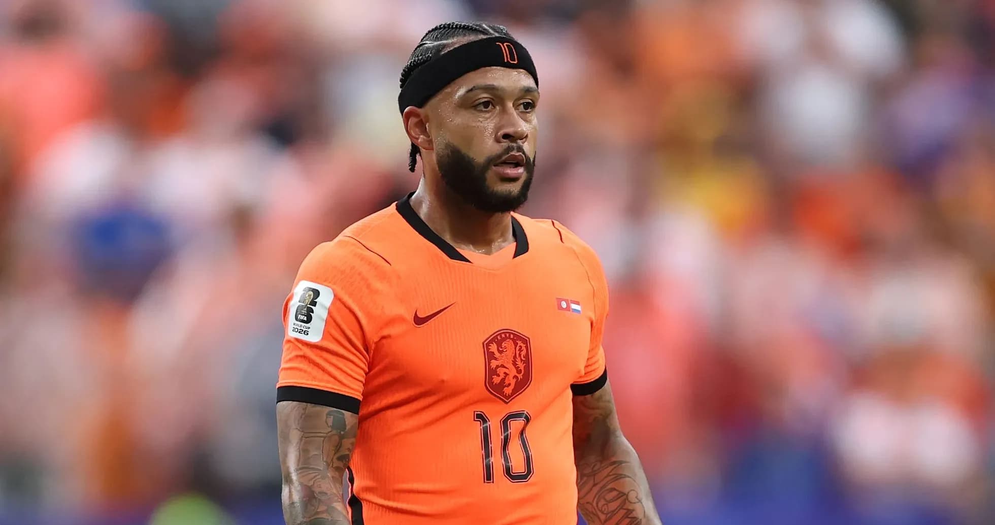 Player in orange jersey during football match Player in orange jersey during football match
