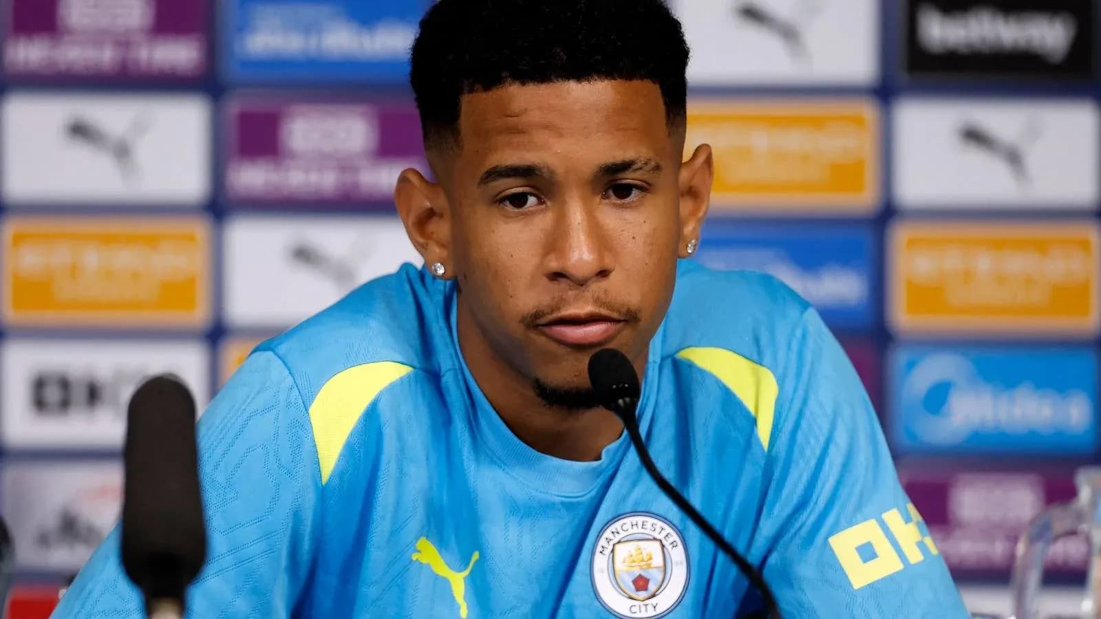 Player speaking at press conference with microphone Player speaking at press conference with microphone