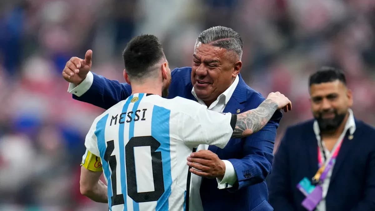 Lionel Messi embracing a man in a suit Lionel Messi embracing a man in a suit