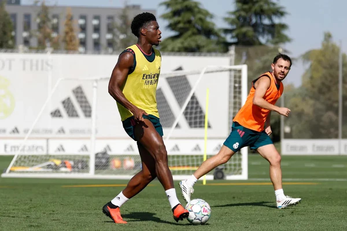 Two players training on the pitch during practice Two players training on the pitch during practice