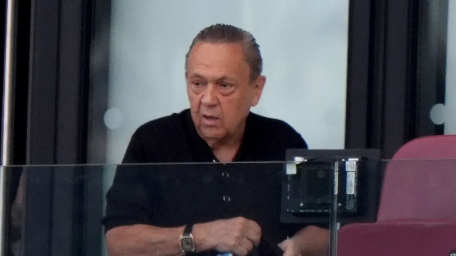 Man in a black shirt observing from a box Man in a black shirt observing from a box