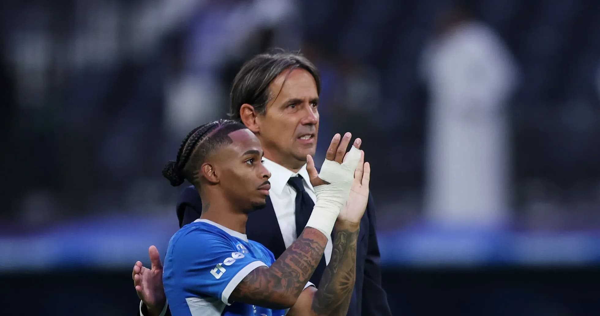 Player and coach acknowledging the crowd after match Player and coach acknowledging the crowd after match
