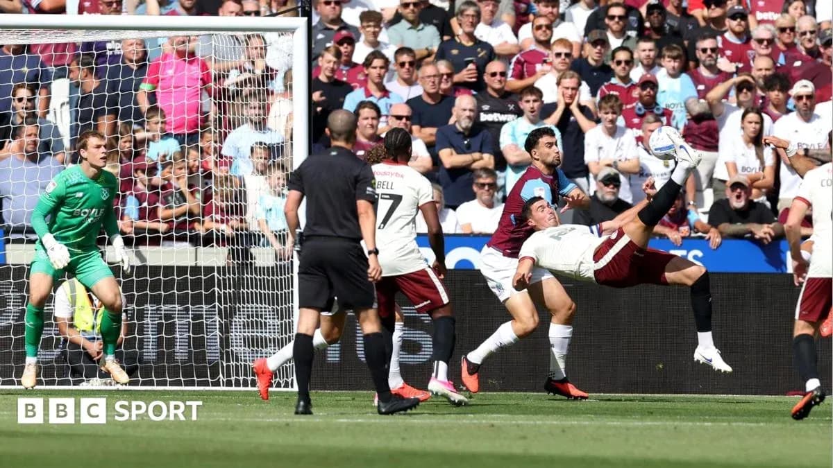 Player attempting acrobatic kick near goal during match Player attempting acrobatic kick near goal during match