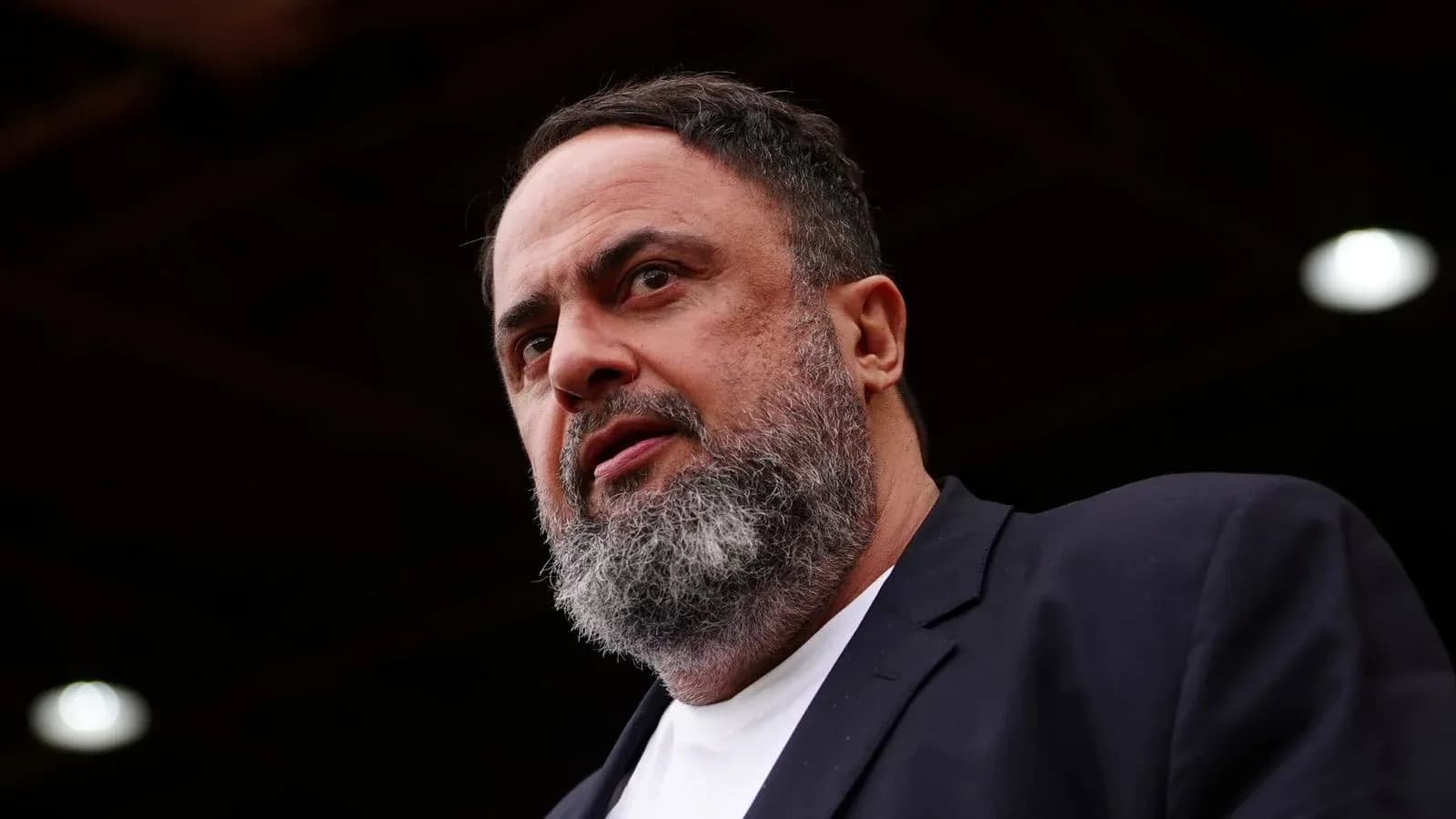 Man with beard speaking at an event Man with beard speaking at an event