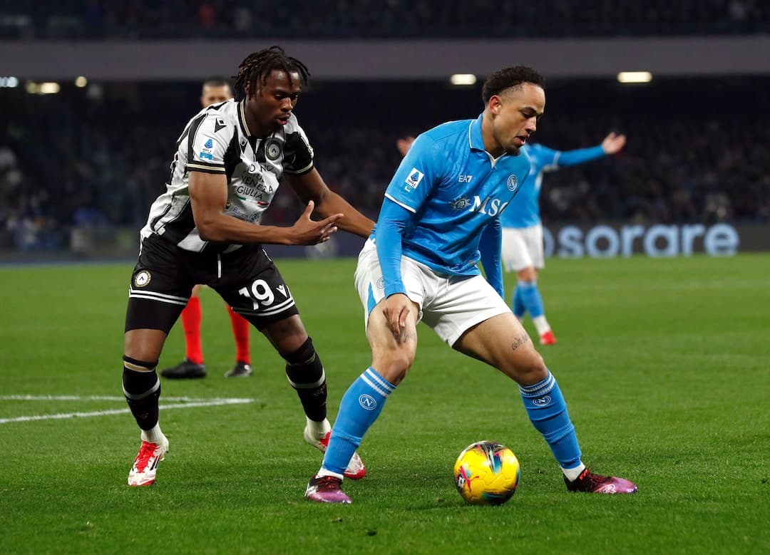 Napoli player challenged by Udinese opponent Napoli player challenged by Udinese opponent