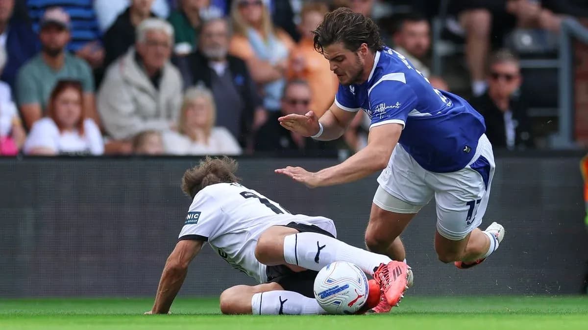 Player falling after a challenge during football match Player falling after a challenge during football match