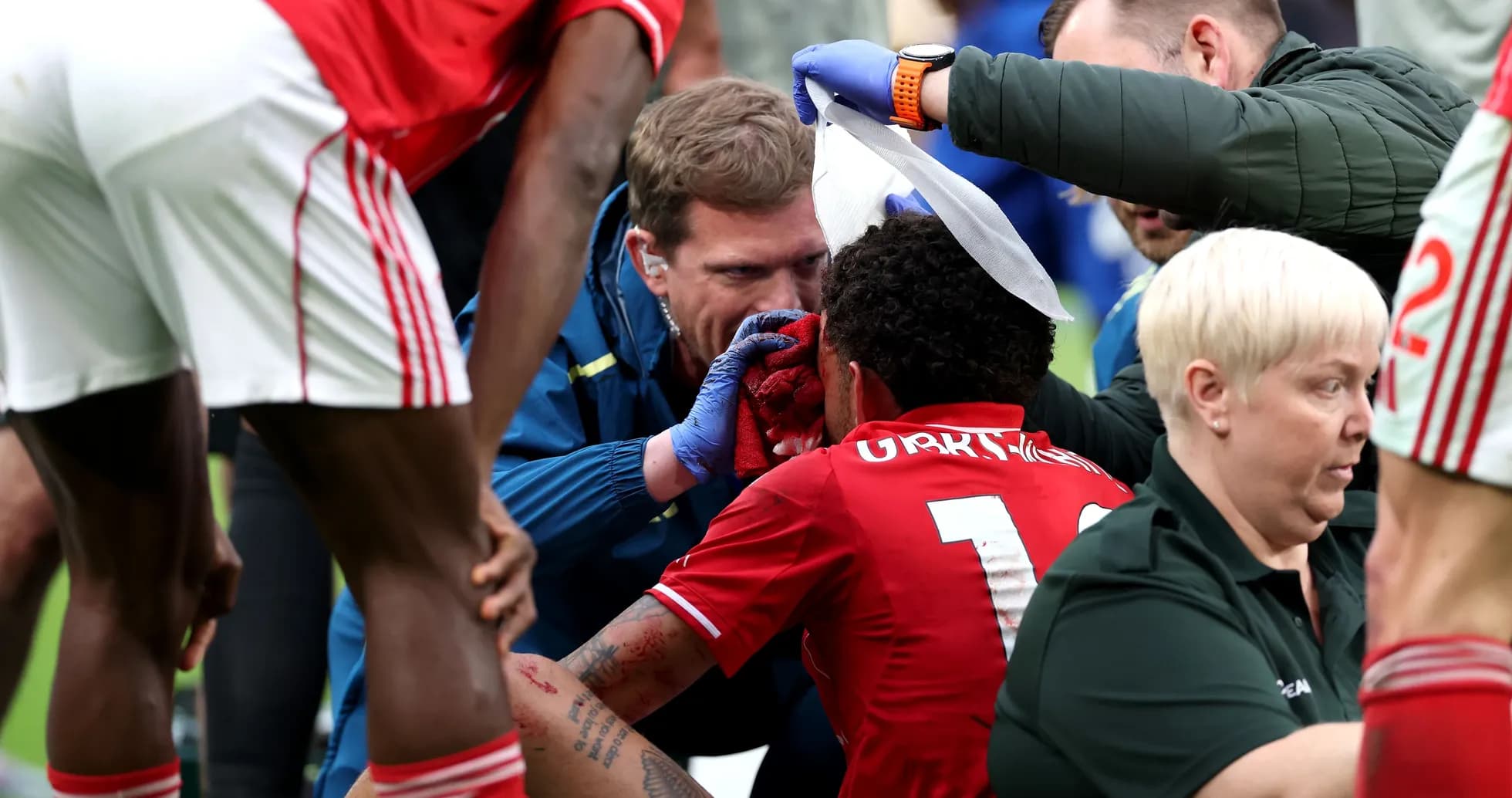 Medical staff treating injured player on the field Medical staff treating injured player on the field