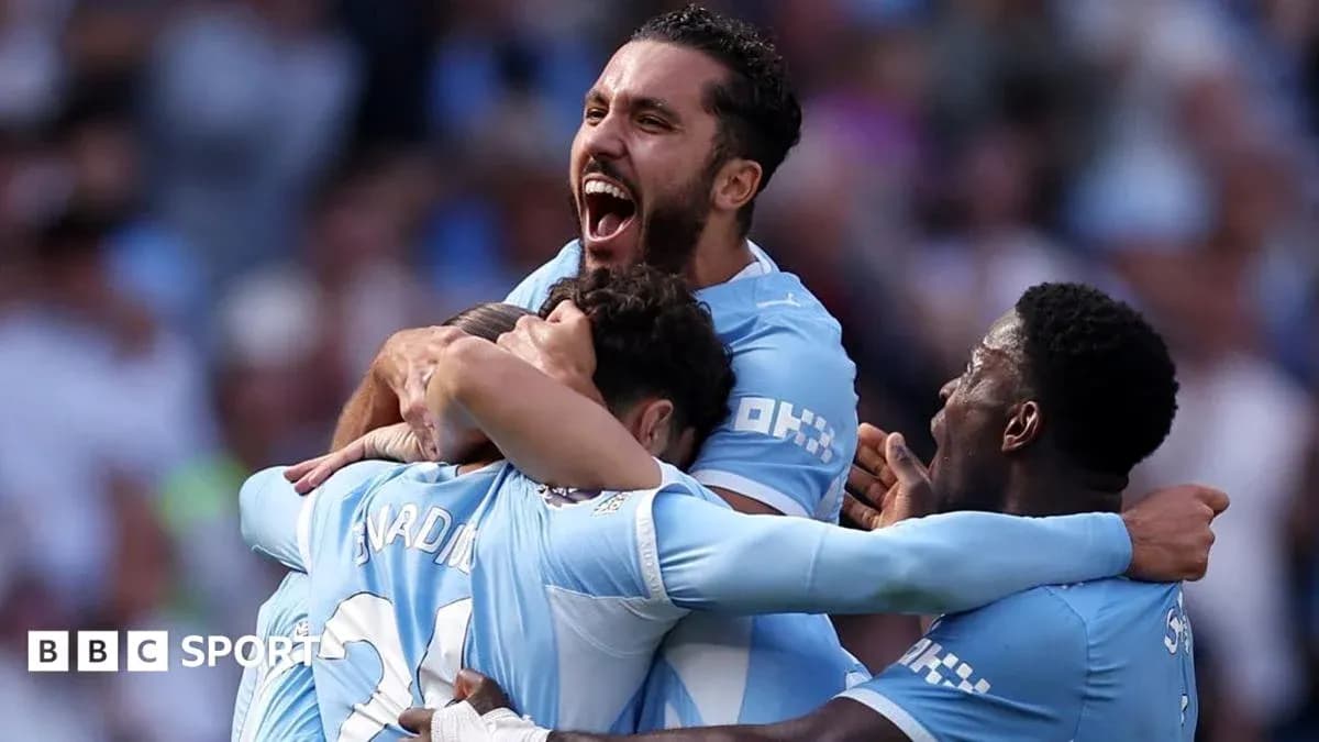 Players celebrating a goal on the pitch Players celebrating a goal on the pitch