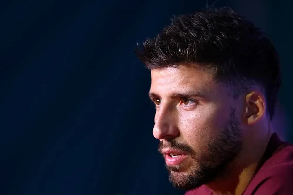 Player speaking at press conference with serious expression Player speaking at press conference with serious expression