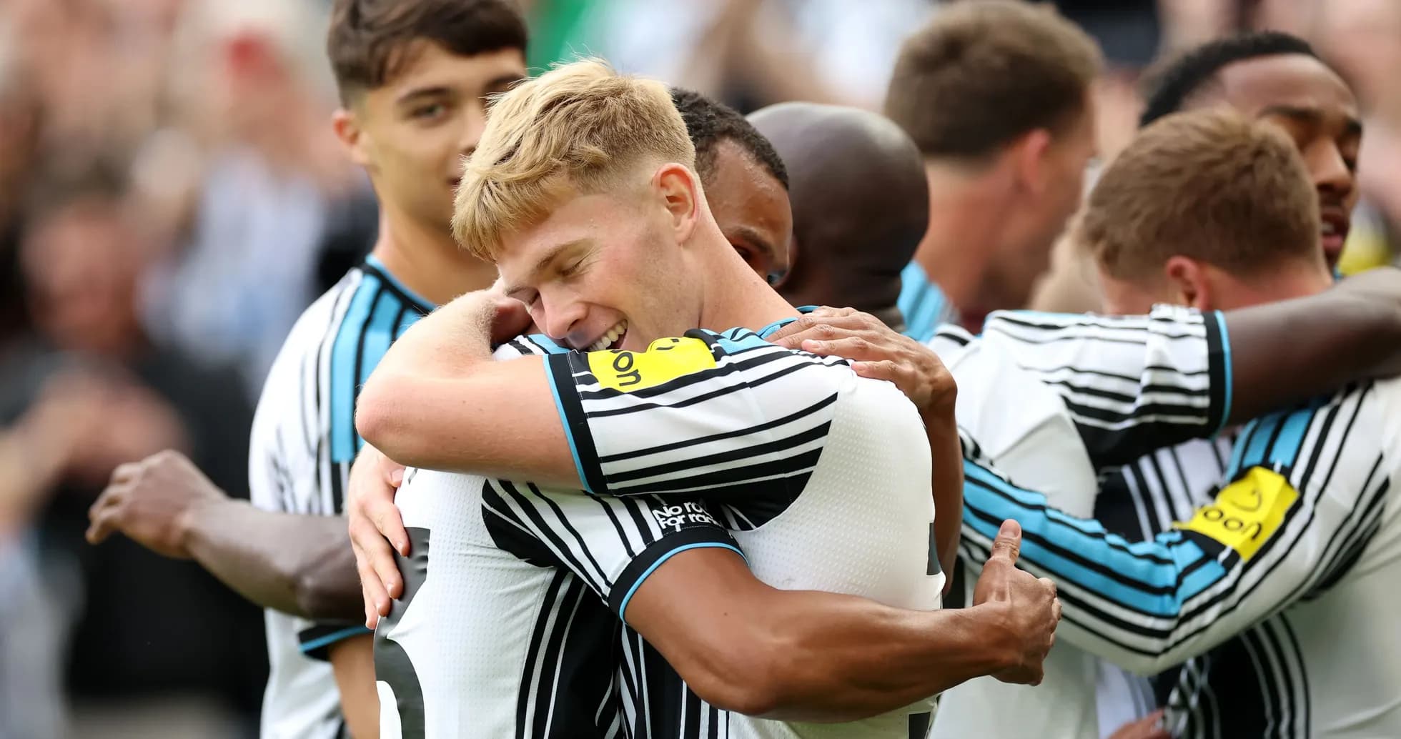 Players celebrating with hugs after a goal Players celebrating with hugs after a goal