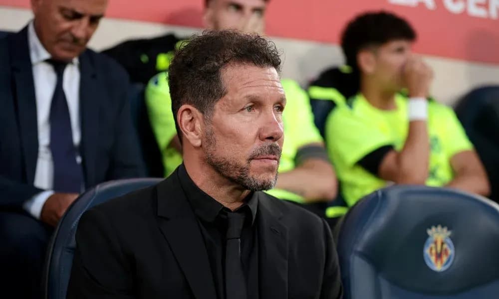 Coach seated on bench during match at stadium Coach seated on bench during match at stadium