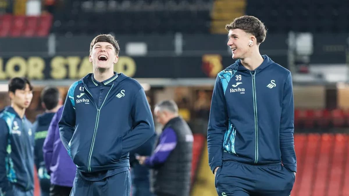 Two Swansea City players laughing during warm-up Two Swansea City players laughing during warm-up