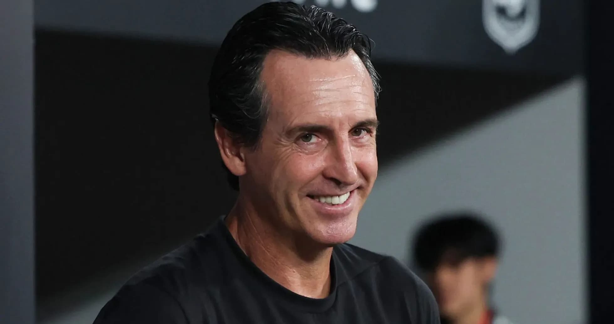 Football manager smiling during a match Football manager smiling during a match
