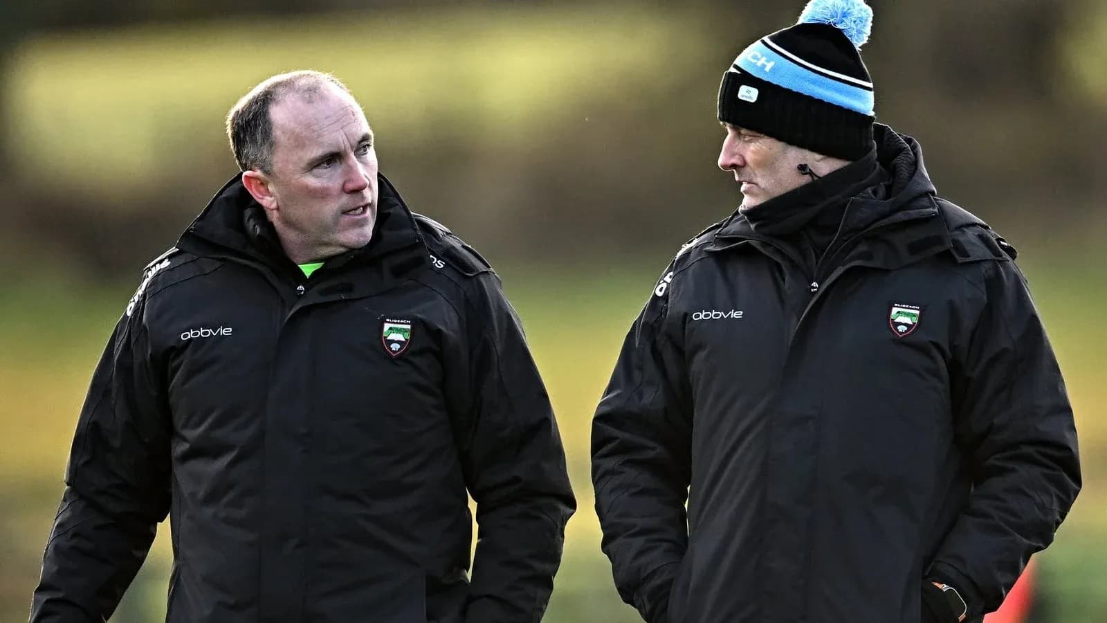 Two coaches discussing strategies during training session Two coaches discussing strategies during training session
