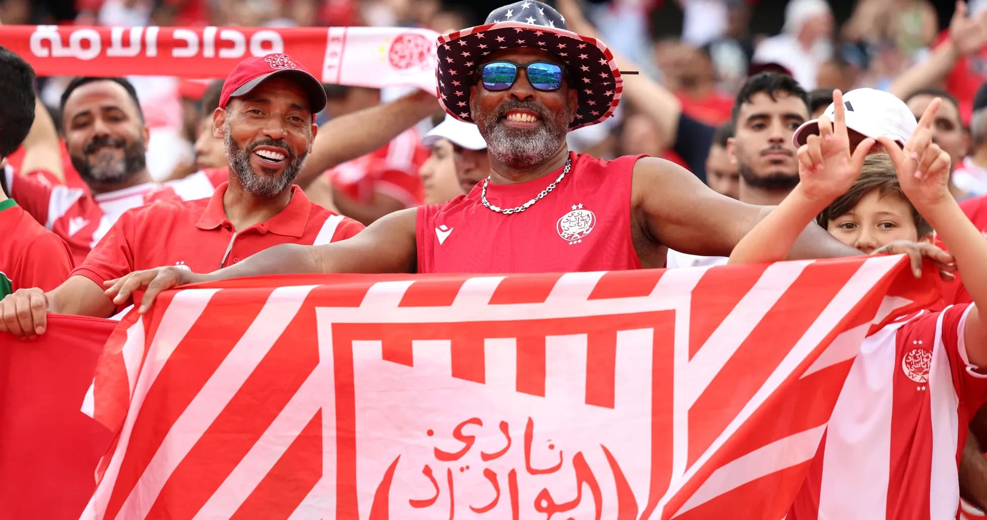 Fans celebrating with a club flag in stadium Fans celebrating with a club flag in stadium