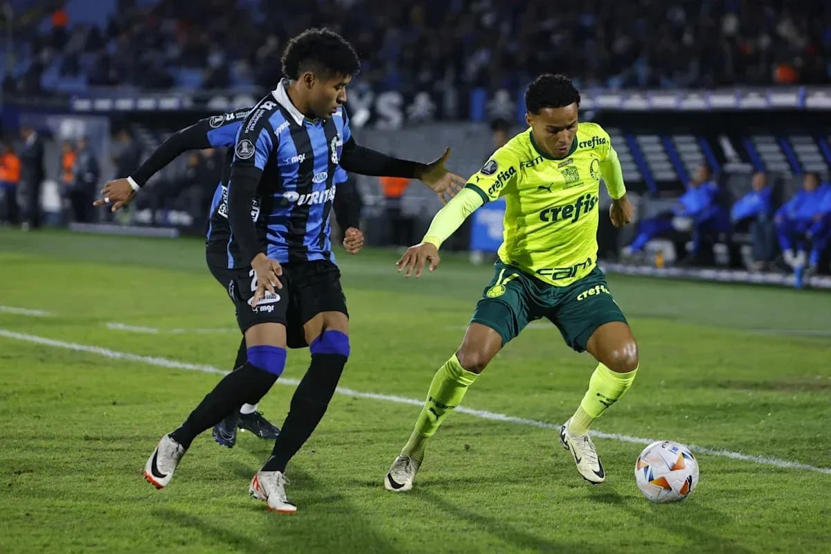 Two players competing for the ball on the field Two players competing for the ball on the field