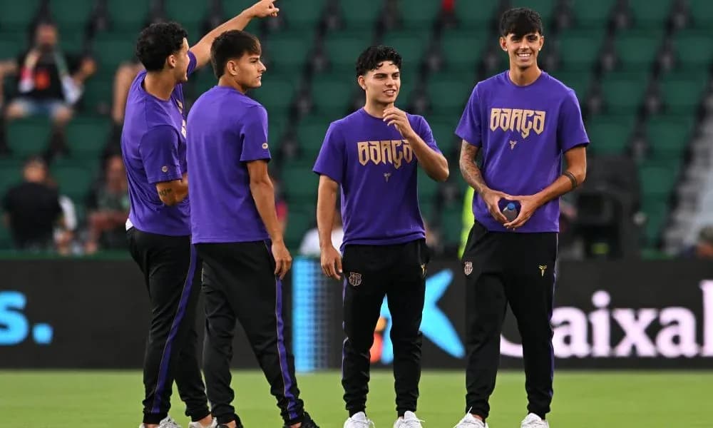 Players in purple shirts warming up on field Players in purple shirts warming up on field